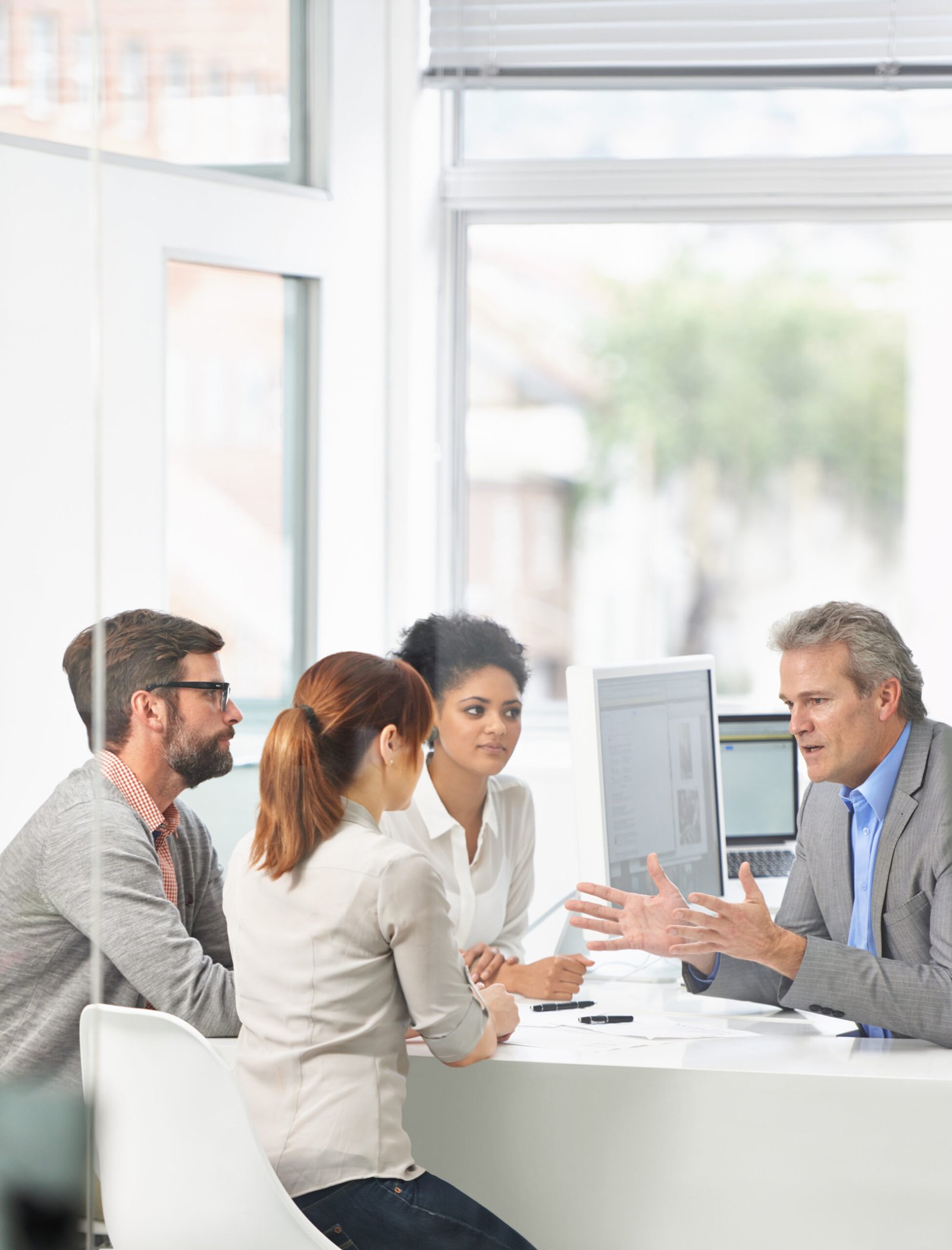 Laying down his ideas. A group of businesspeople going over some plans together