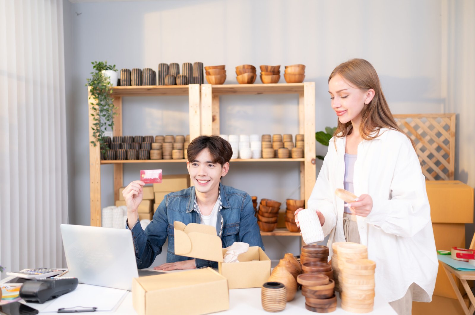 A young couple runs a small business. making clay ornaments Providing payment services by credit card